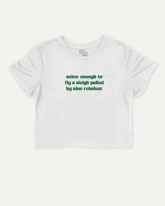 Sober Enough To Fly A Sleigh Pulled By Nine Reindeer graphic crop tee with funny and trendy slogan print, Perfect Gift for Christmas, X-mas Gift,  perfect for women’s casual looks or layering. White crop t-shirt.