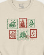 Beige t-shirt with Christmas-themed stamps design on a white background
