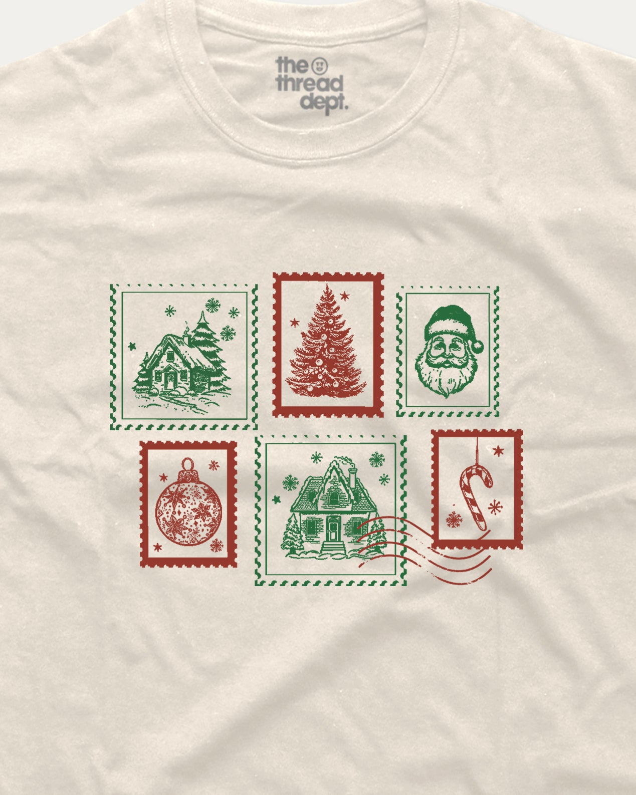 White t-shirt with Christmas-themed stamps design on a white background