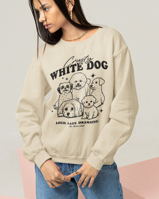Beige sweatshirt with Crusty white dog graphic design and text worn by a person on a light background