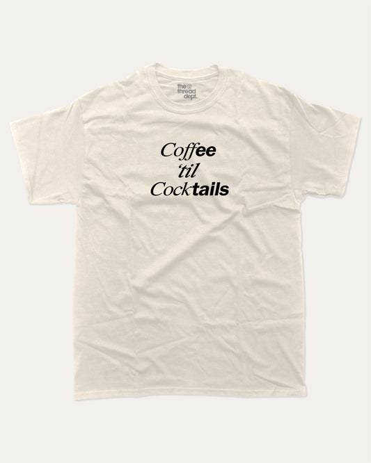 Coffee Til Cocktails graphic tee with bold and humorous print, Perfect Gift to Coffee Lover, Caffeine Graphic T shirt, funny and trendy graphic. Perfect for adults and gift-giving. Cream shirt.