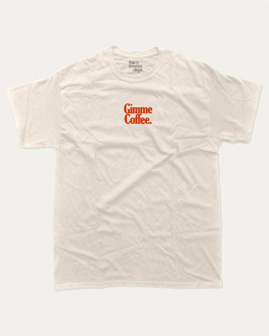 Gimme Coffee graphic tee with bold and humorous print, funny and trendy graphic. Coffee Lover Graphic T shirt, Caffeine Lover Graphic T shirt,  Perfect for adults and gift-giving. Cream shirt.