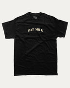 Oat Milk graphic t-shirt with bold and humorous print, funny and trendy graphic. Perfect funny gifts for friends. Black shirt.