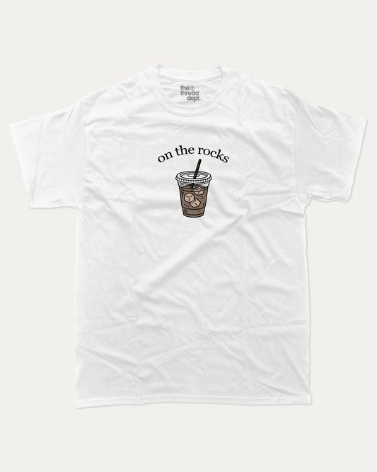 on the rocks graphic tee with bold and humorous print, Perfect Gift for Coffee Lover, Coffee Drinks Graphic T shirt,  funny and trendy graphic. Perfect for adults and gift-giving. White shirt.