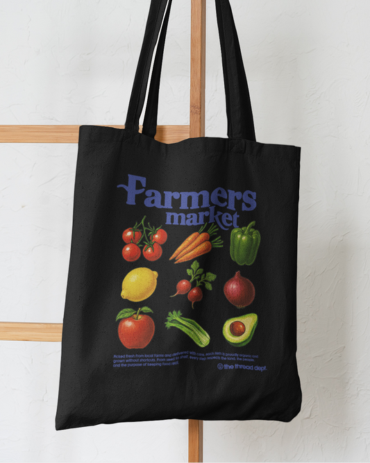 Black tote bag with colorful illustrations of vegetables and 'Farmers market' text on a white background