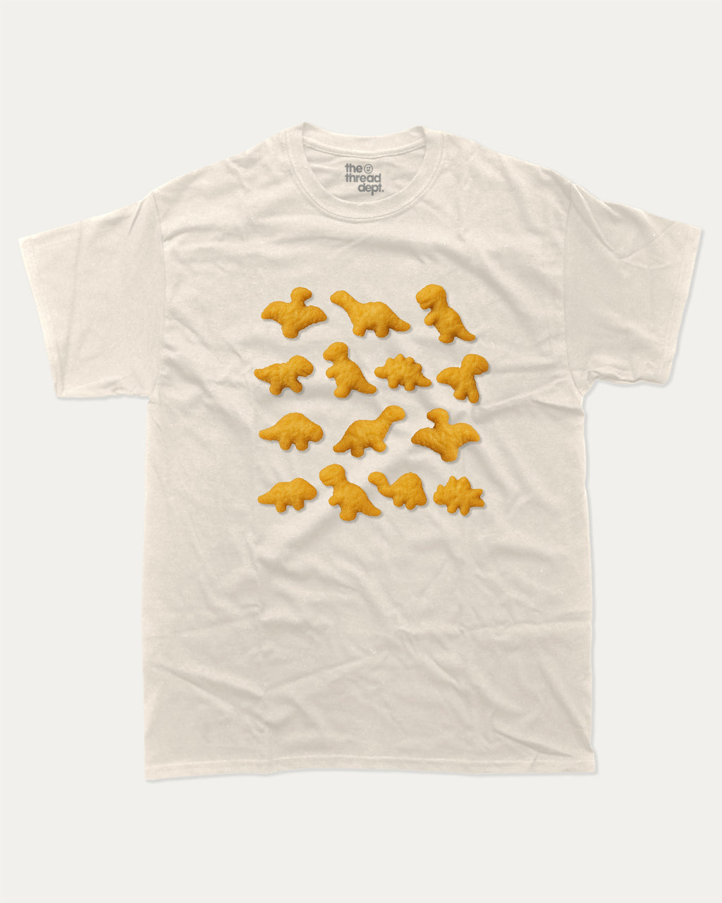 Dino Nugget graphic tee with bold and humorous print, funny nugget graphic. Perfect for adults and gift-giving. Cream shirt.