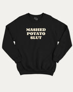 Mashed Potato Slut graphic sweatshirt with bold and humorous print, warm and cozy graphic for everyday wear. Perfect for adults and gift-giving. Black pullover.