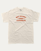 Most Valuable Snack Coordinator graphic tee with bold and humorous print, funny and trendy graphic. Food Lover Graphic T shirt, Snack Lover T shirt, Perfect for adults and gift-giving. Cream shirt.