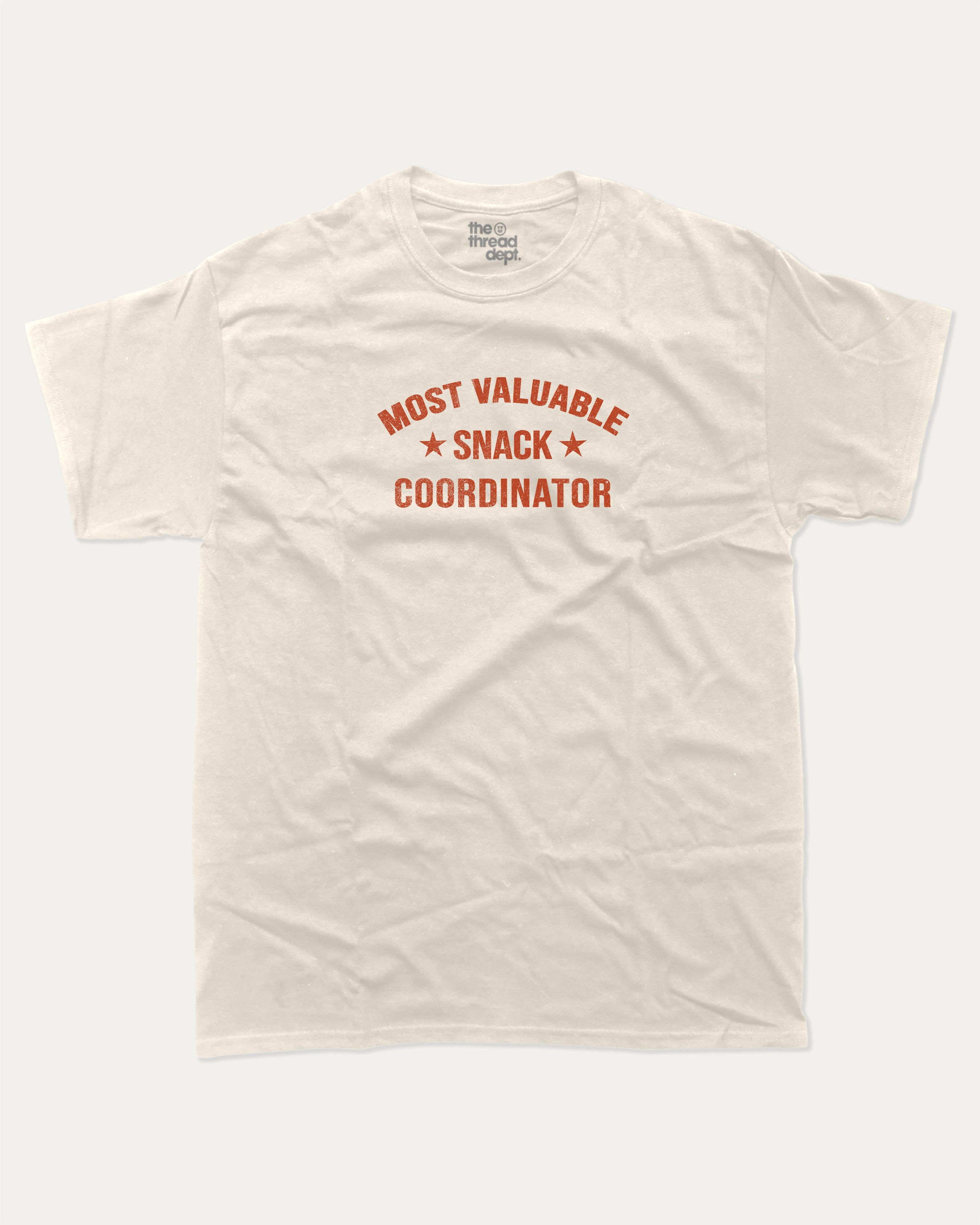 Most Valuable Snack Coordinator graphic tee with bold and humorous print, funny and trendy graphic. Food Lover Graphic T shirt, Snack Lover T shirt, Perfect for adults and gift-giving. Cream shirt.