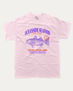 Oceanside Seafood graphic tee with bold and humorous print, Food Graphic Tee, Seafood Lover, Retro Inspired Graphic T shirt, Cute Retro Vintage Graphic T shirt, funny and trendy graphic. Perfect for adults and gift-giving. Pink shirt.