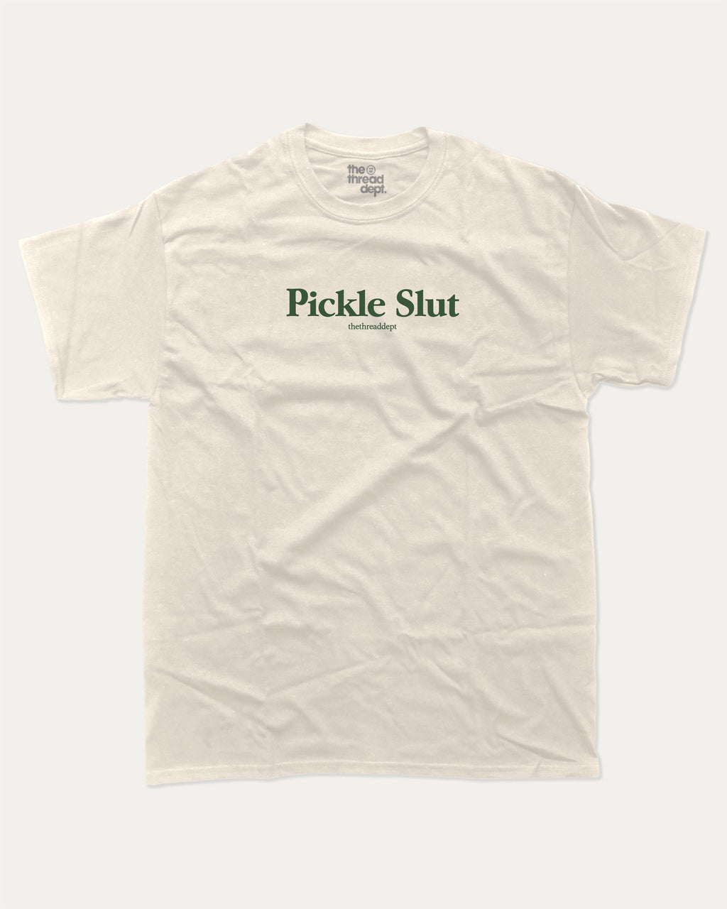 Pickle Slut graphic tee with bold and humorous print, funny and trendy graphic. Perfect Gift for Food Lover, Pickle Graphic T shirt, Craving Graphic T shirt, Snack Graphic T shirt,  Perfect for adults and gift-giving. Cream shirt.
