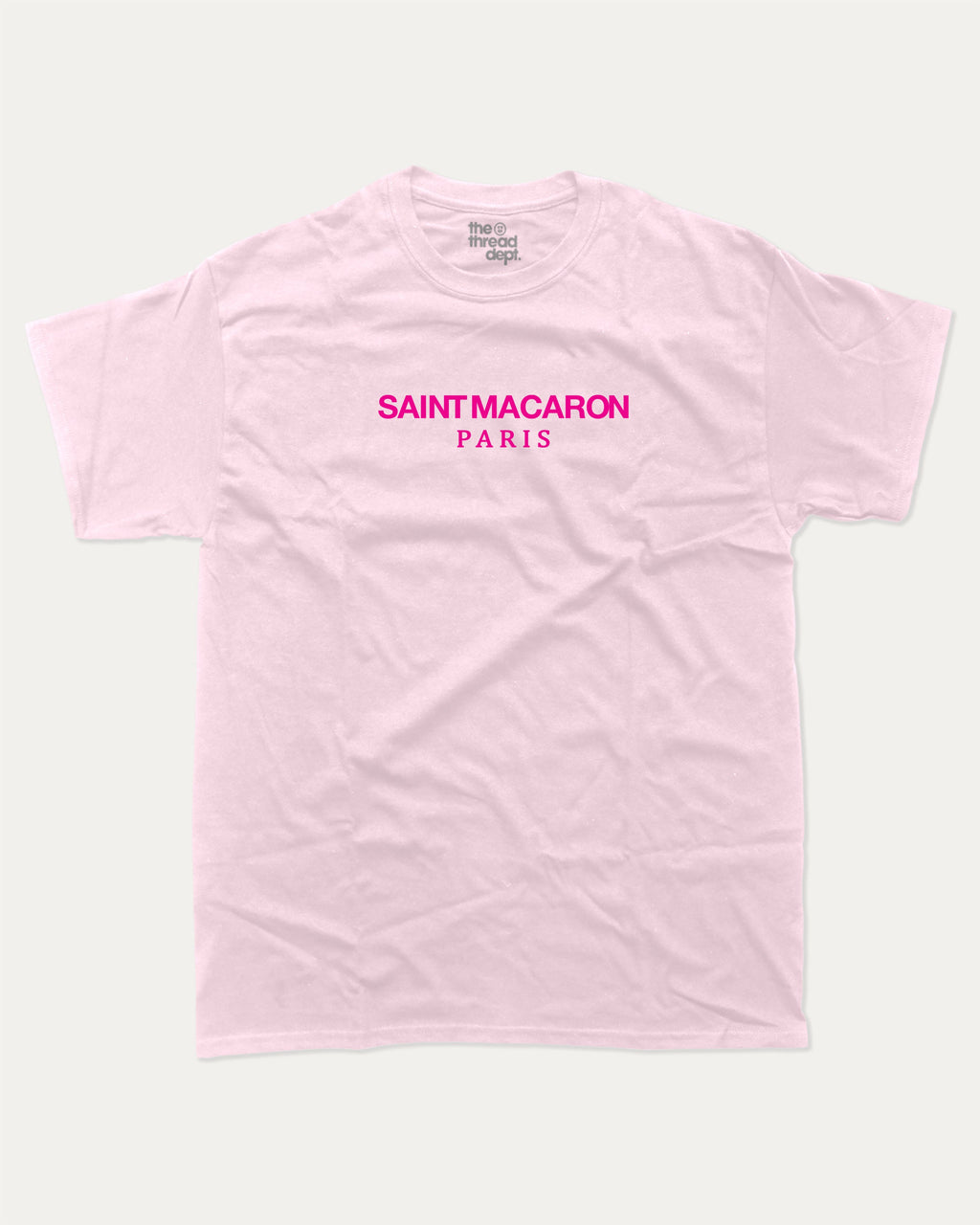 Saint Macaron graphic tee with bold and humorous print, funny and trendy graphic. Food Lover Graphic T shirt, Snack Lover T shirt, Perfect for adults and gift-giving. Pink shirt.