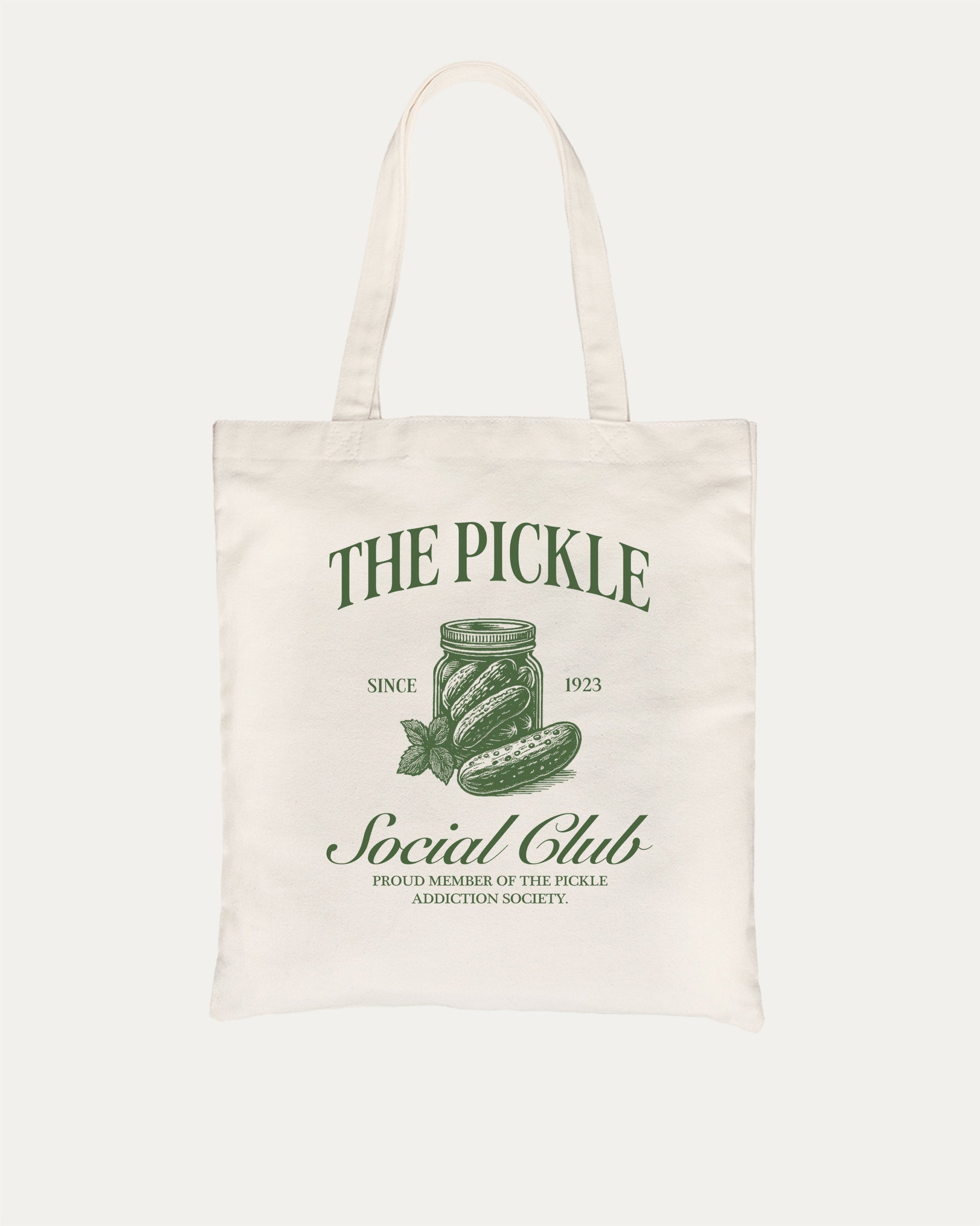 The Pickle Social Club cotton canvas tote bag with humorous graphic. Funny pickle graphic t-shirt – the perfect quirky gift for pickle lovers who enjoy playful fashion and lighthearted style.