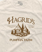 Beige t-shirt with brown graphic of a pumpkin patch and text 'Hagrid's Pumpkin Farm' on a beige background.