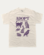 Adopt Black Magic Animals graphic tee with bold and humorous print, Perfect Gift for Halloween Day, Halloween Day Graphic T shirt,  funny and trendy graphic. Perfect for adults and gift-giving. Cream shirt.
