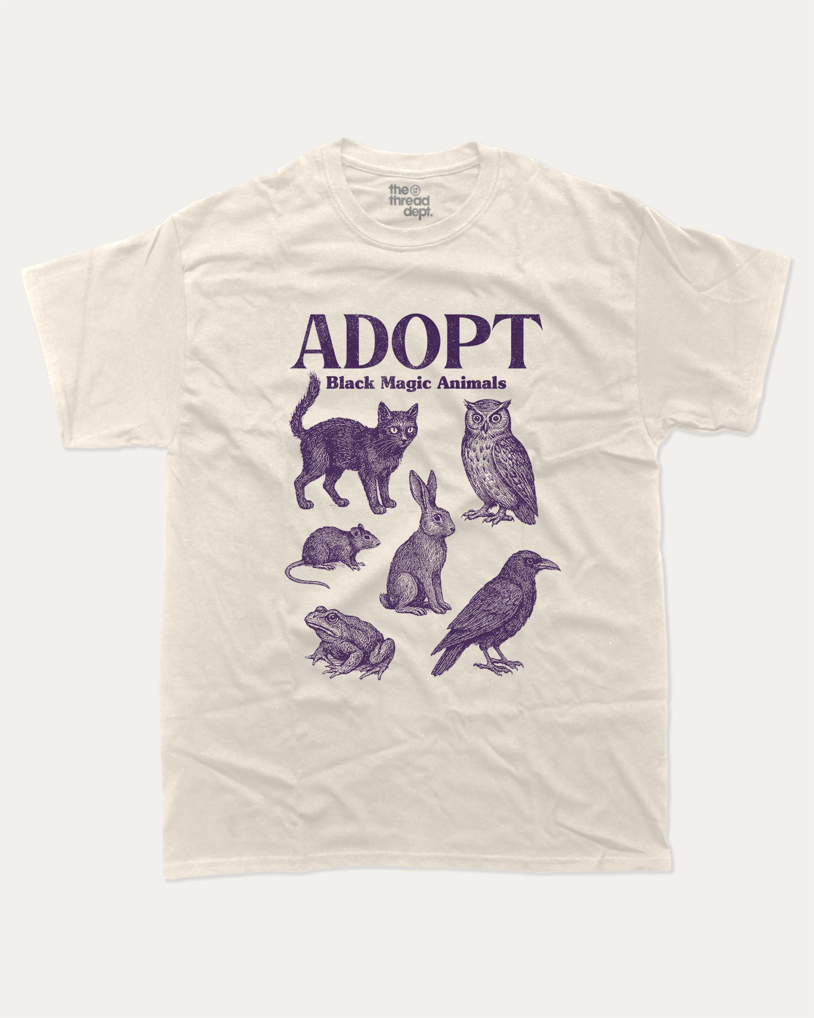 Adopt Black Magic Animals graphic tee with bold and humorous print, Perfect Gift for Halloween Day, Halloween Day Graphic T shirt,  funny and trendy graphic. Perfect for adults and gift-giving. Cream shirt.
