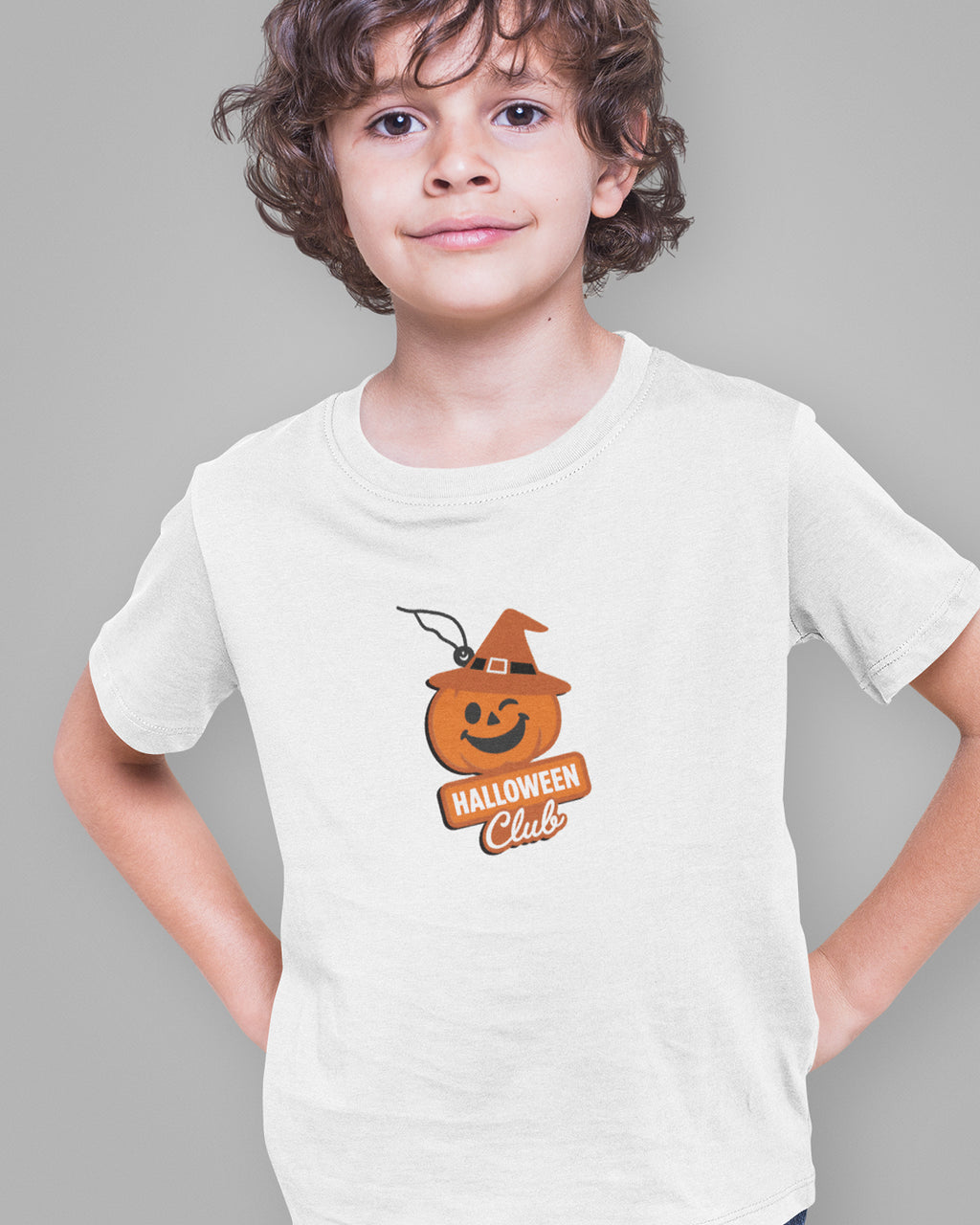 Child wearing a white t-shirt with a Halloween-themed design on a gray background