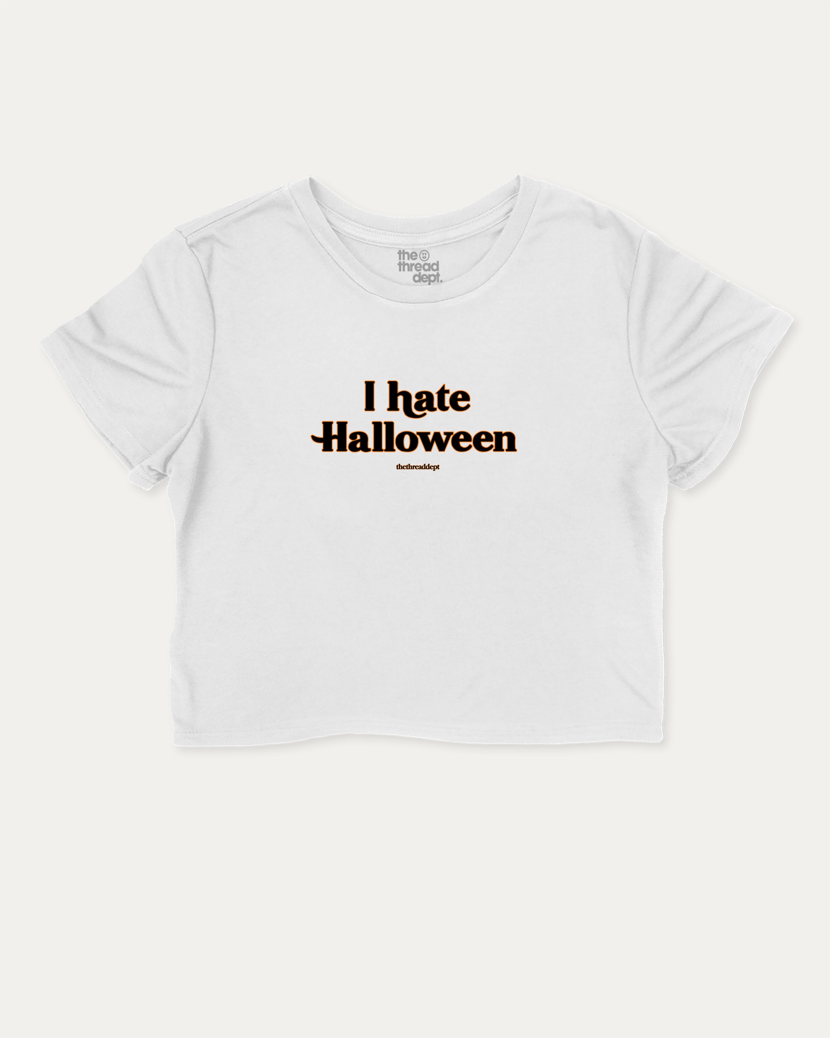 I Hate Halloween graphic crop tee with funny and trendy slogan print, perfect for women’s casual looks or layering. White crop t-shirt.