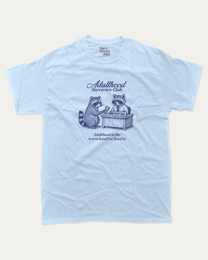 Adulthood Survivors Club graphic t-shirt, perfect for adults. Vintage Retro T shirt, Funny Racoon T shirt, Cute Racoon T shirt, Vintage Graphic Tee, unique gift idea. Powder Blue.