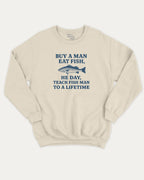 Buy A Man Eat Fish He Day Teach Fish Man To A Lifetime graphic sweatshirt with bold and humorous print, warm and cozy graphic for everyday wear. Perfect for adults and gift-giving. Natural pullover.