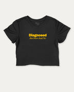 Diagnosed But Mom Said No graphic crop tee with funny and trendy slogan print, perfect for women’s casual looks or layering. Black crop t-shirt.