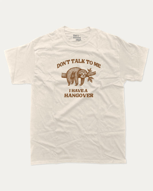Don't Talk To Me I Have A Hangover graphic t-shirt, Funny quote graphic t-shirt with witty text  great for casual wear, conversation starters, and adding humor to your everyday outfit. Cream.