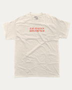 Eat Italian Kiss French graphic tee with bold and humorous print, funny and trendy graphic. Perfect for adults and gift-giving. Cream shirt.