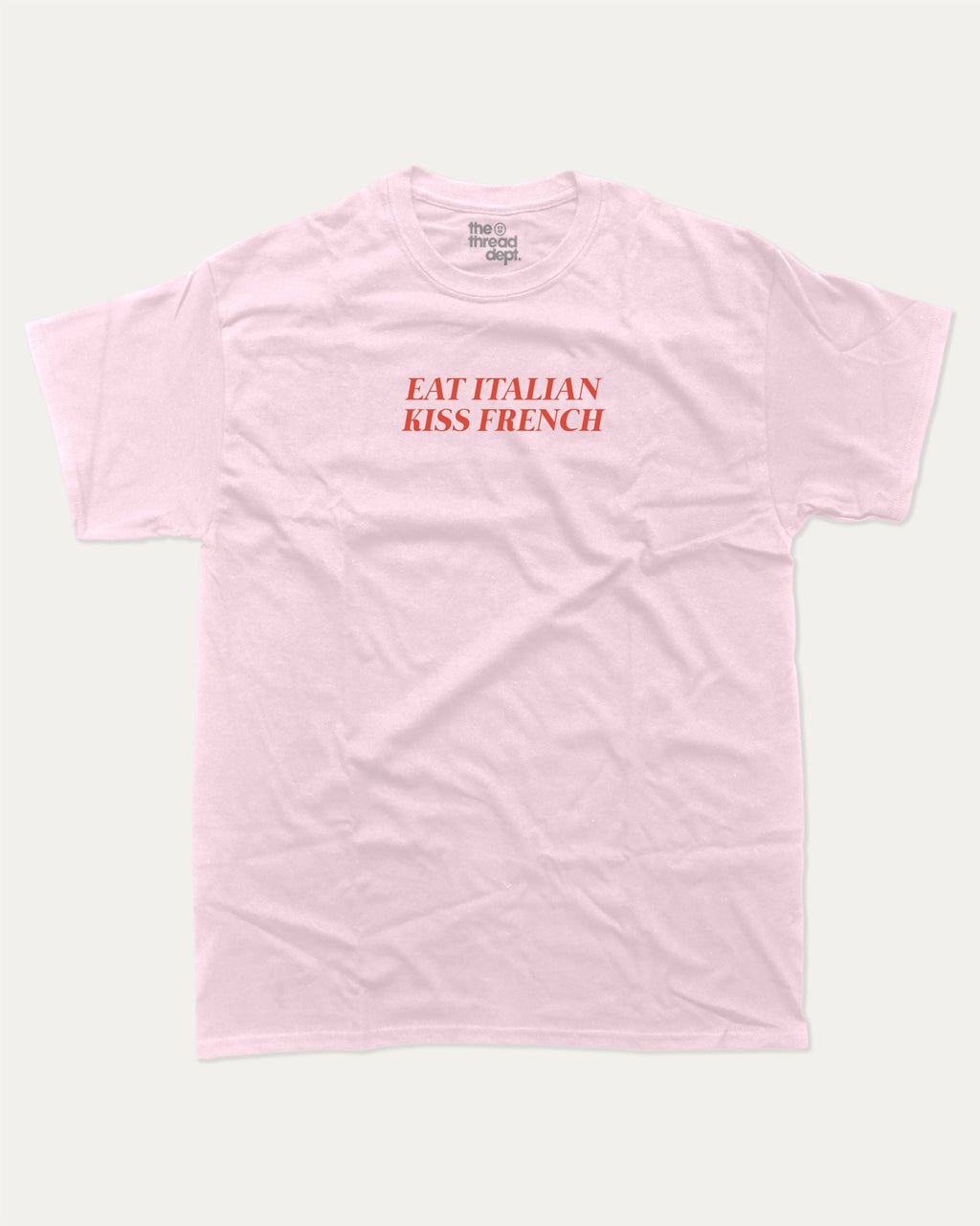 Eat Italian Kiss French graphic tee with bold and humorous print, funny and trendy graphic. Perfect for adults and gift-giving. Pink shirt.