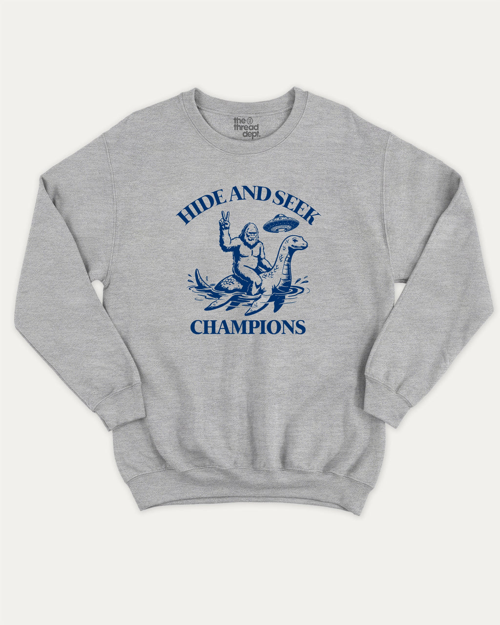Hide and Seek Champions bigfoot graphic sweatshirt with bold and humorous print, warm and cozy graphic for everyday wear. Perfect funny gifts for friends and gift-giving. Heather Grey pullover.