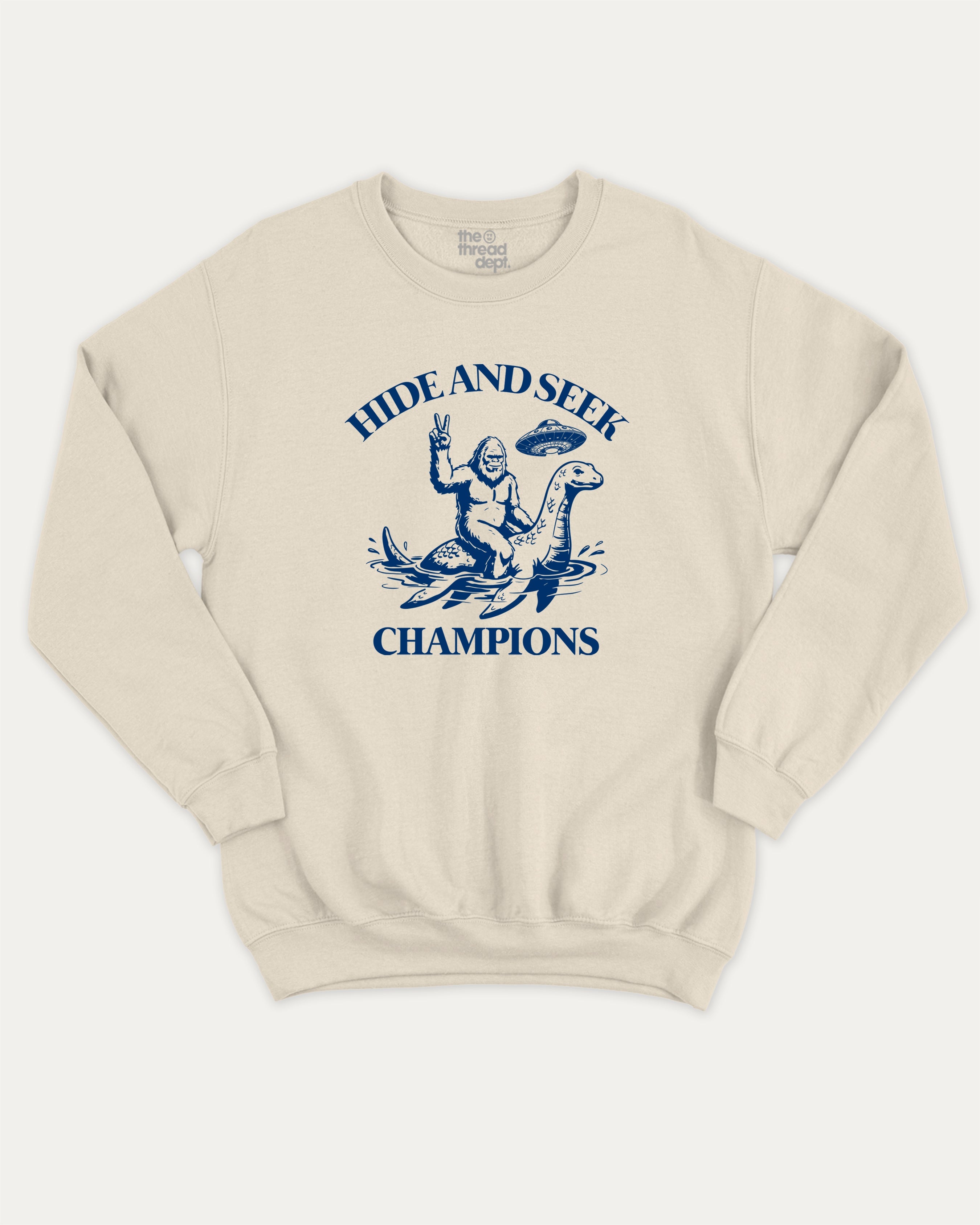 Hide and Seek Champions bigfoot graphic sweatshirt with bold and humorous print, warm and cozy graphic for everyday wear. Perfect funny gifts for friends and gift-giving. Natural pullover.