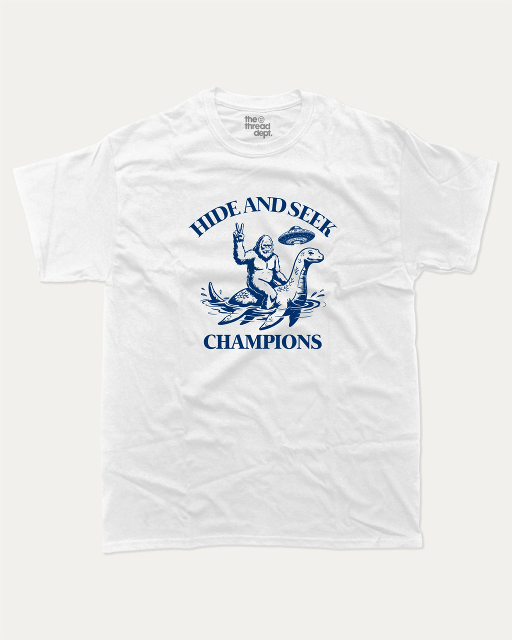 Hide and Seek Champions bigfoot graphic tee with retro and funny print, vintage and trendy graphic. Perfect funny gifts for friends and gift-giving. White shirt.