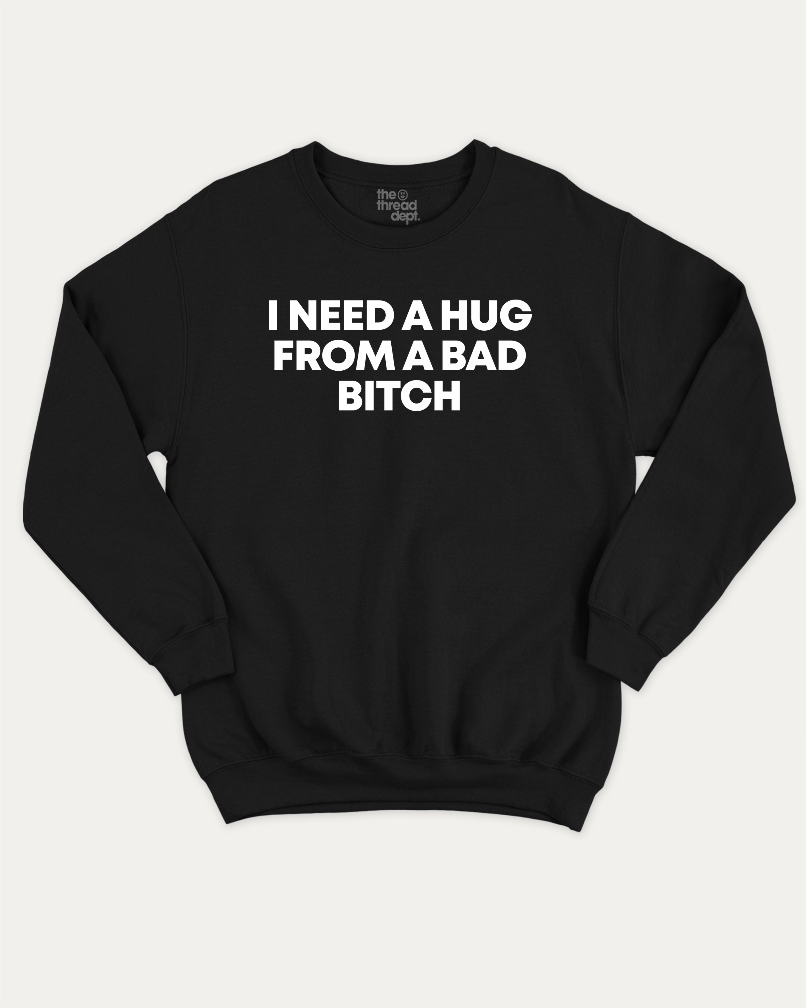 I need a hug from a bad bitch graphic sweatshirt with bold and humorous print, Funny meme graphic tee, warm and cozy graphic for everyday wear. Perfect for adults and gift-giving. Black pullover.