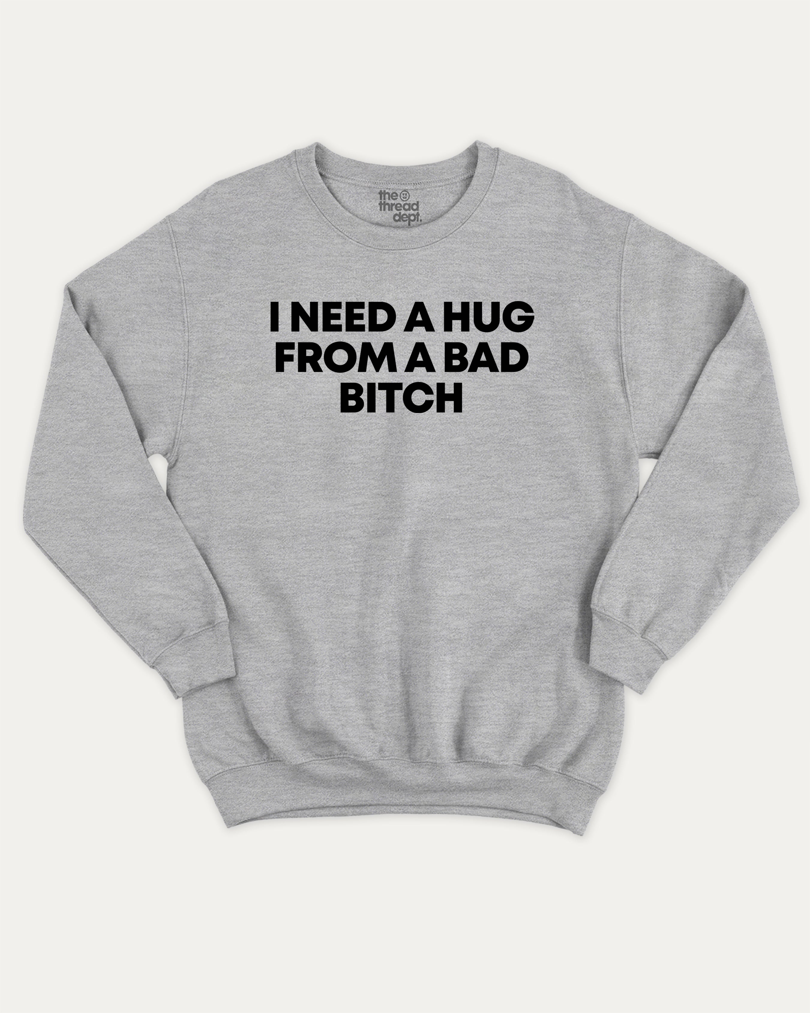 I need a hug from a bad bitch graphic sweatshirt with bold and humorous print, Funny meme graphic tee, warm and cozy graphic for everyday wear. Perfect for adults and gift-giving. Heather Grey pullover.