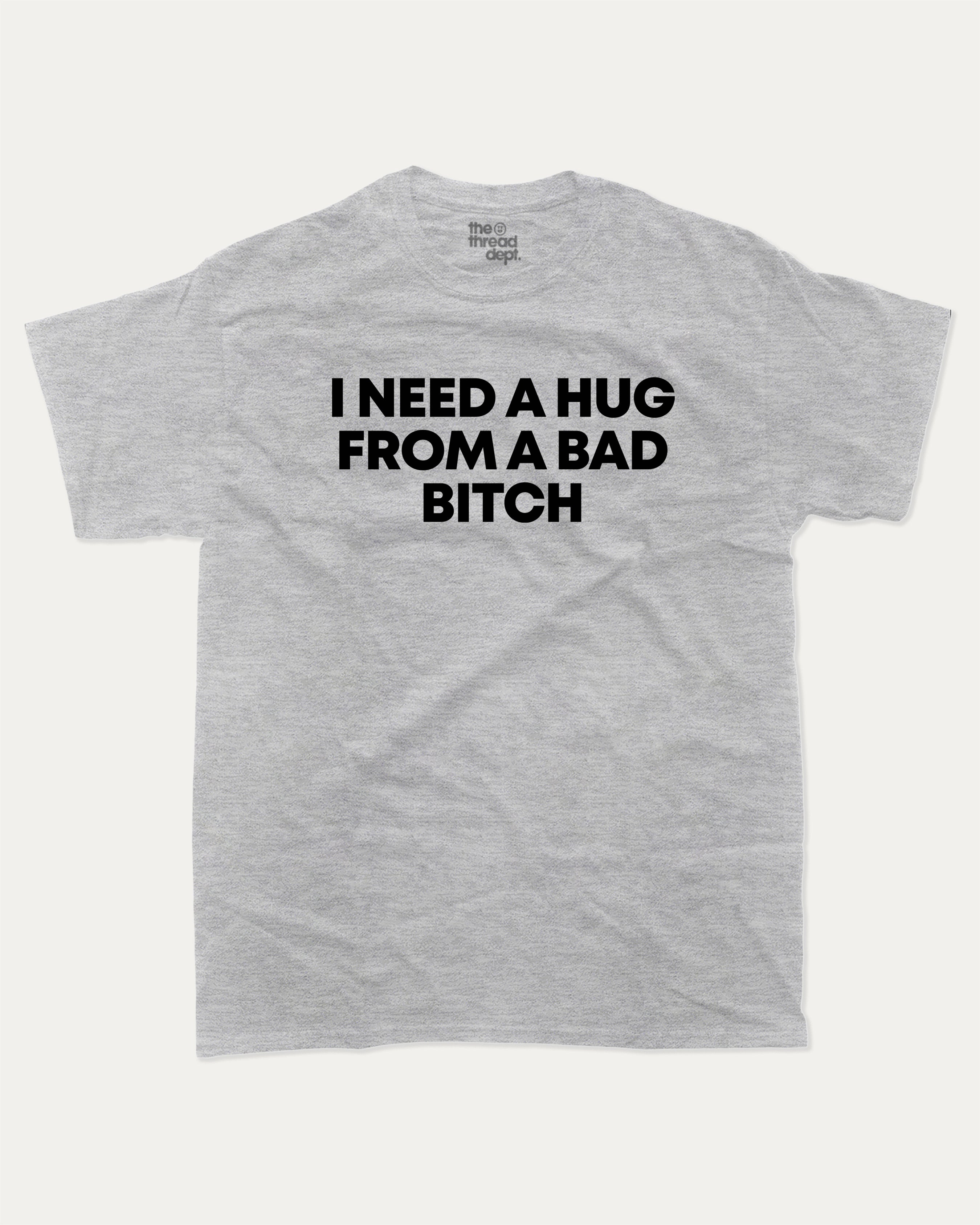 I need a hug from a bad bitch graphic tee with bold and humorous print, Funny meme graphic tee, funny and trendy graphic. Perfect for adults and gift-giving. Heather Grey shirt.