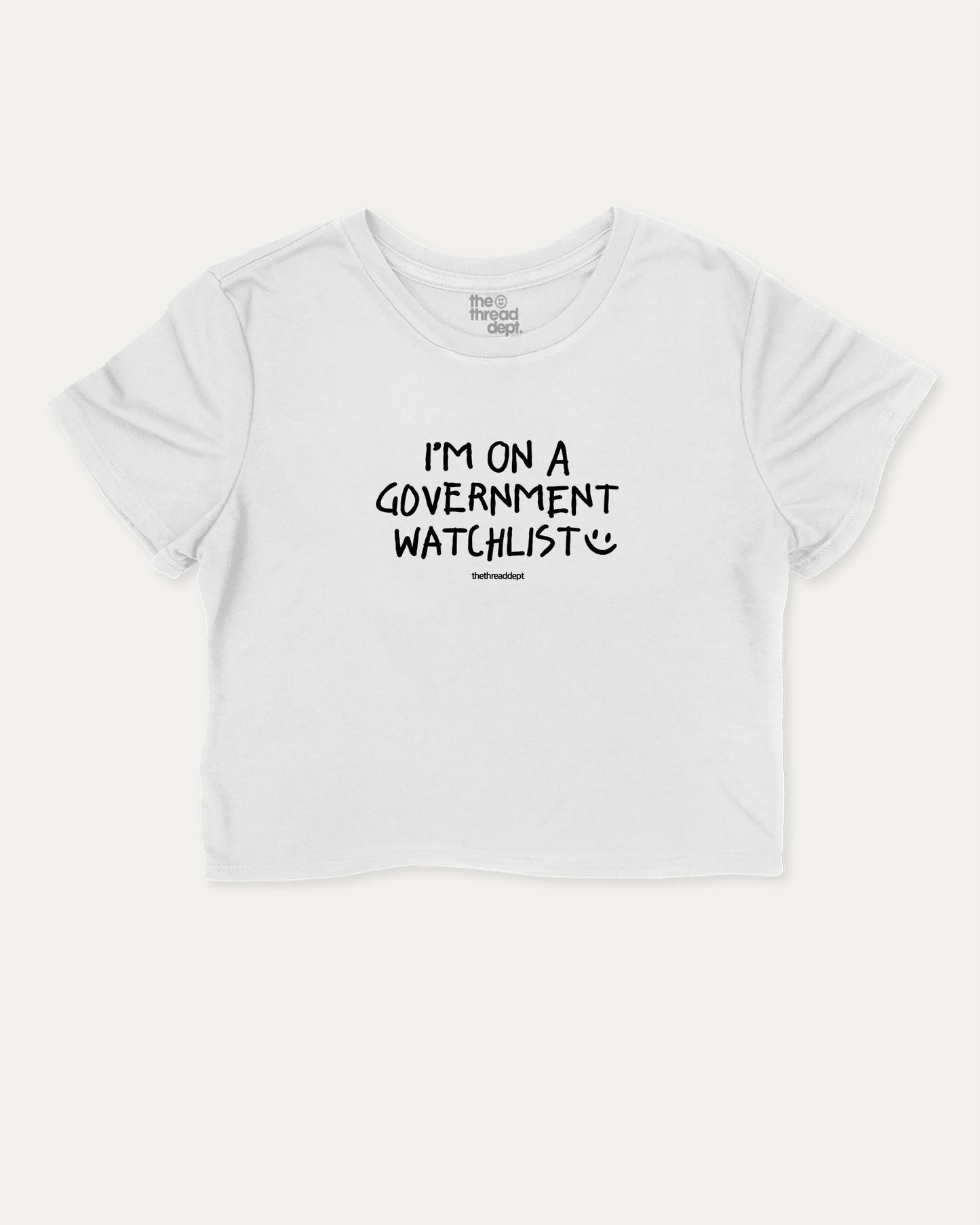 I'm on a government watchlist graphic crop tee with funny and trendy slogan print, perfect for women’s casual looks or layering. White crop t-shirt.