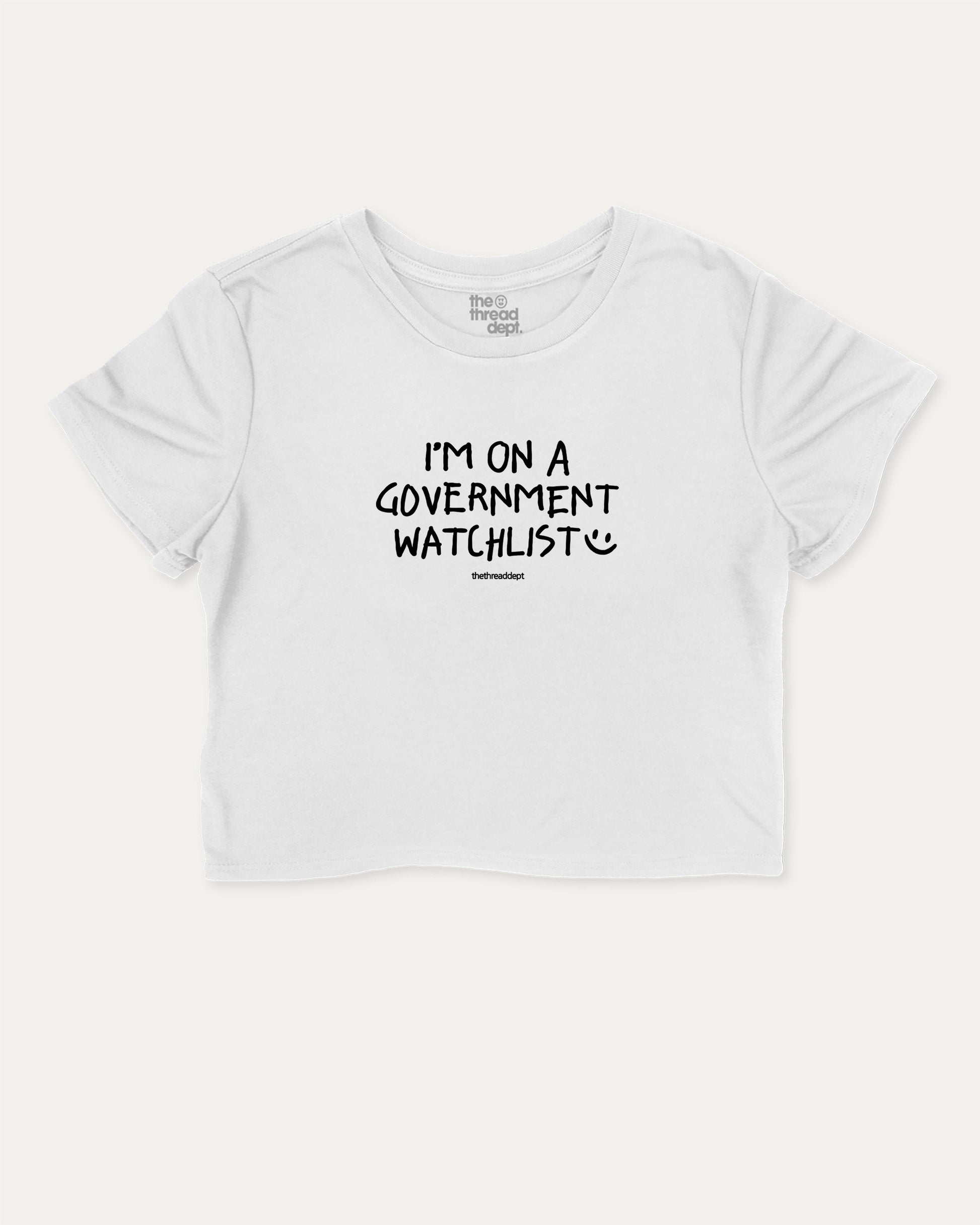I'm on a government watchlist graphic crop tee with funny and trendy slogan print, perfect for women’s casual looks or layering. White crop t-shirt.
