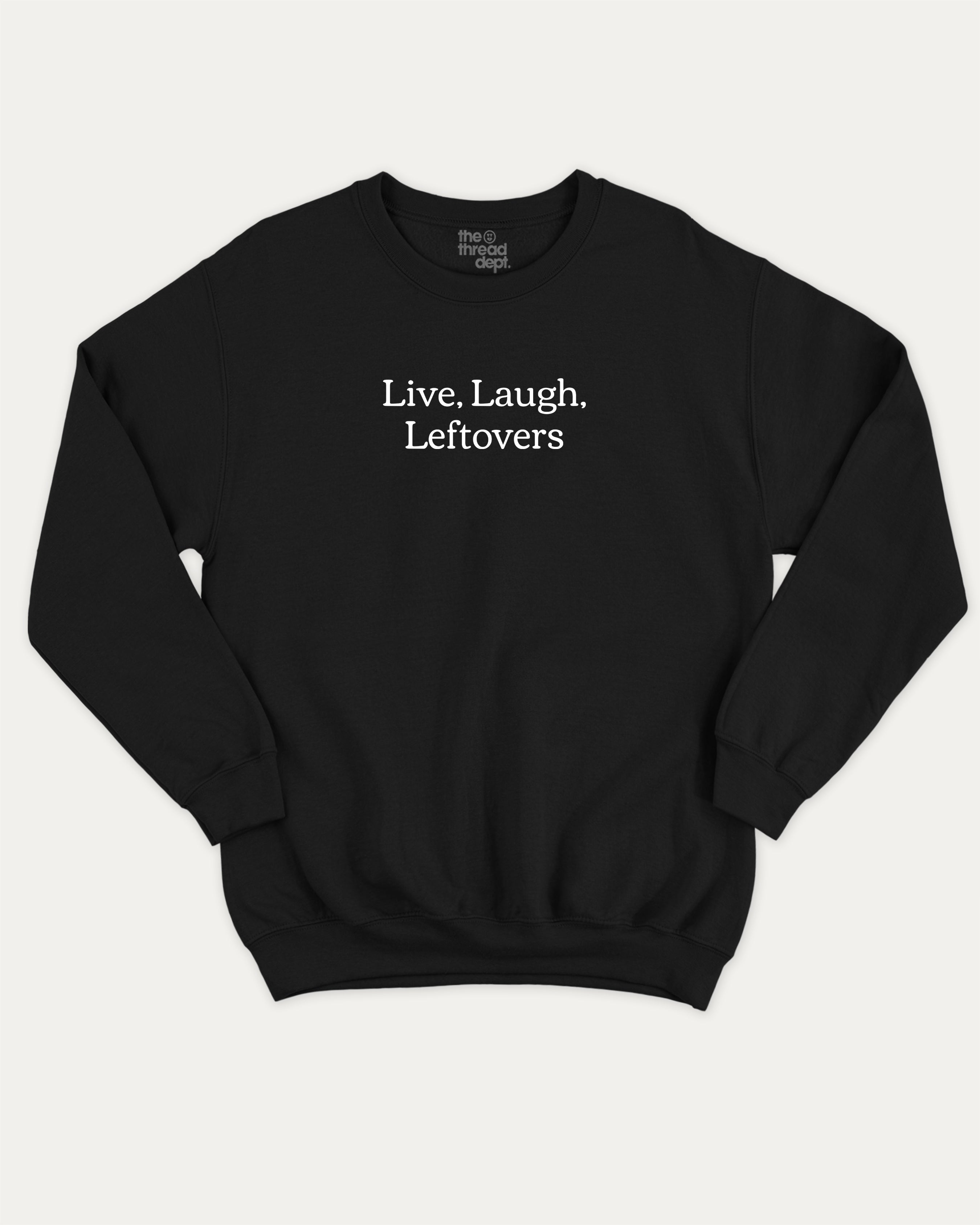 Live Laugh Leftovers graphic sweatshirt with bold and humorous saying print, warm and cozy graphic for everyday wear. Perfect for adults and gift-giving. Black pullover.