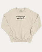 Live Laugh Leftovers graphic sweatshirt with bold and humorous saying print, warm and cozy graphic for everyday wear. Perfect for adults and gift-giving. Natural pullover.