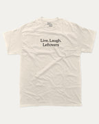 Live Laugh Leftovers graphic tee with bold and humorous saying print, funny and trendy graphic. Perfect for adults and gift-giving. Cream shirt.