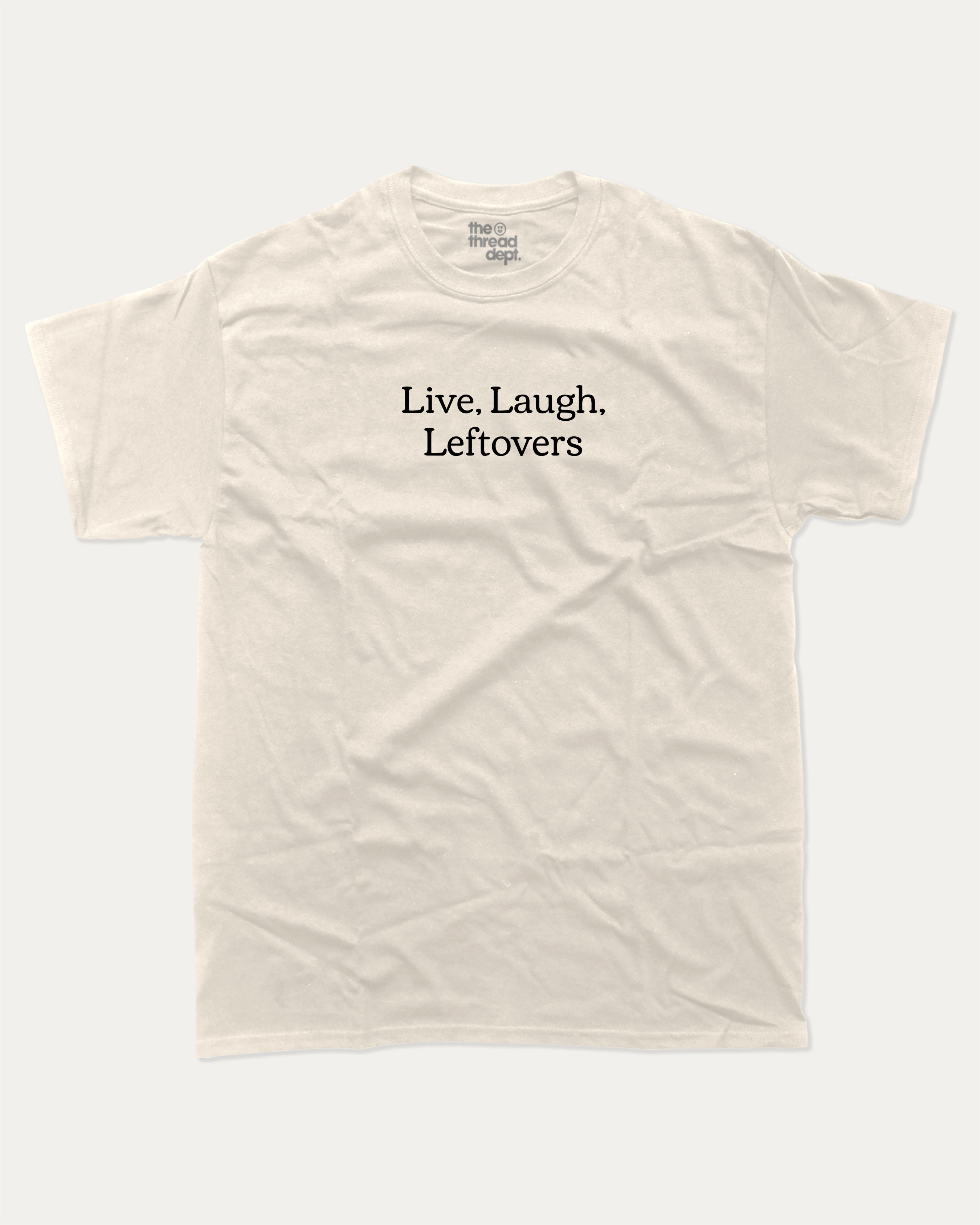 Live Laugh Leftovers graphic tee with bold and humorous saying print, funny and trendy graphic. Perfect for adults and gift-giving. Cream shirt.