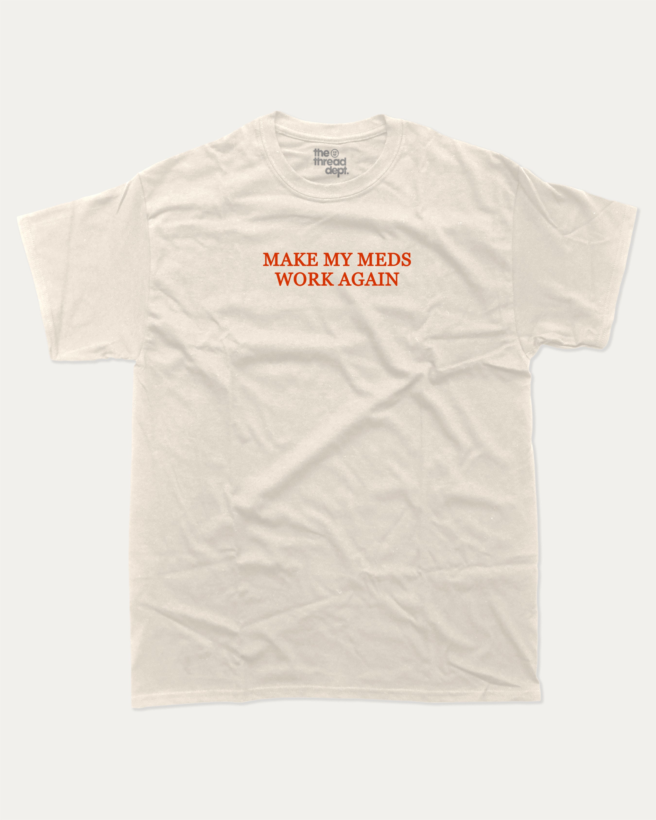 Make my meds work again graphic tee with bold and humorous print, Pun Graphic T shirt, Pun words tee, Funny Pun Graphic tees, funny and trendy graphic. Perfect for adults and gift-giving. Cream shirt.