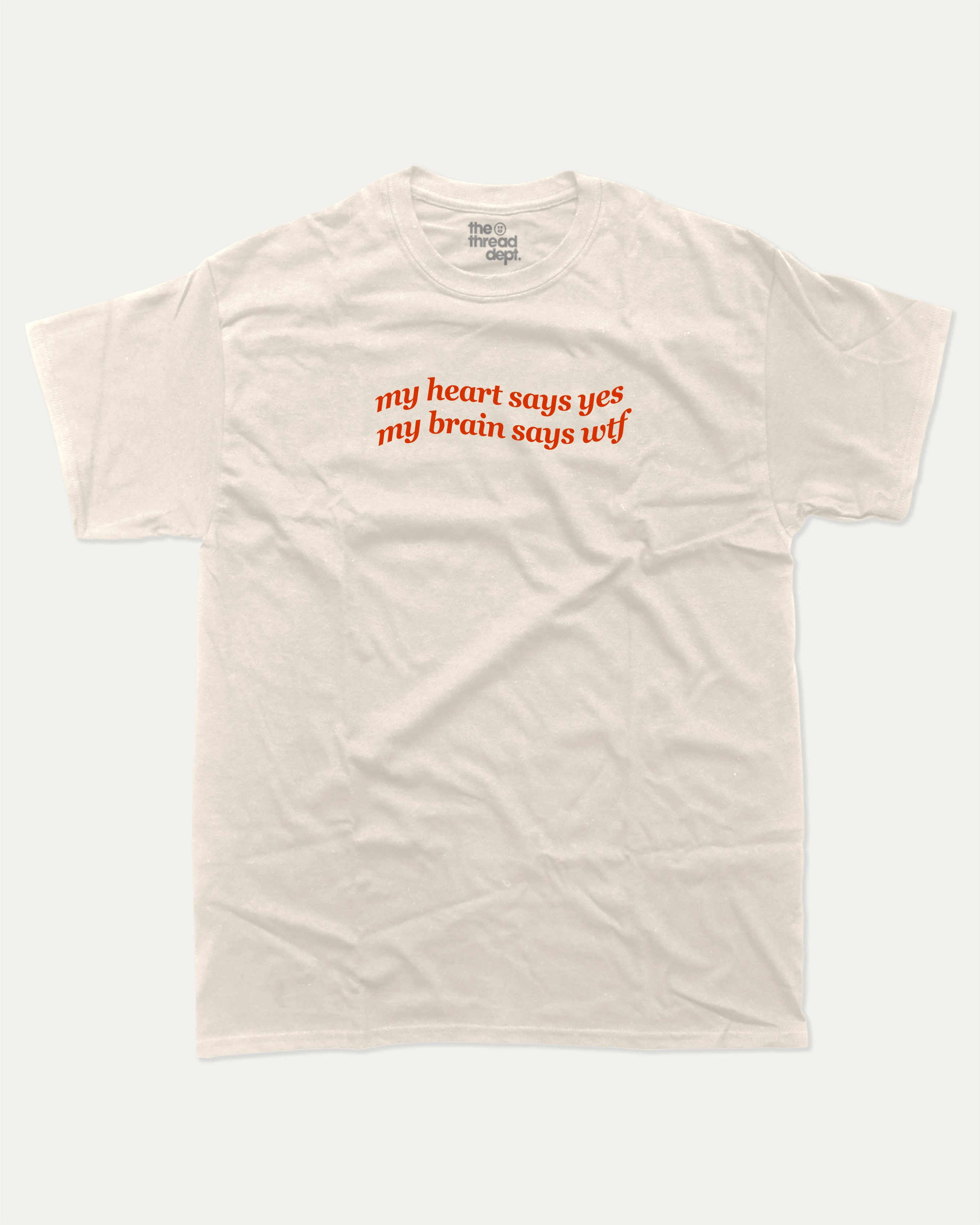my heart says yes my brain says wtf graphic tee with bold and humorous print, funny and trendy graphic. Perfect for adults and gift-giving. Cream shirt.