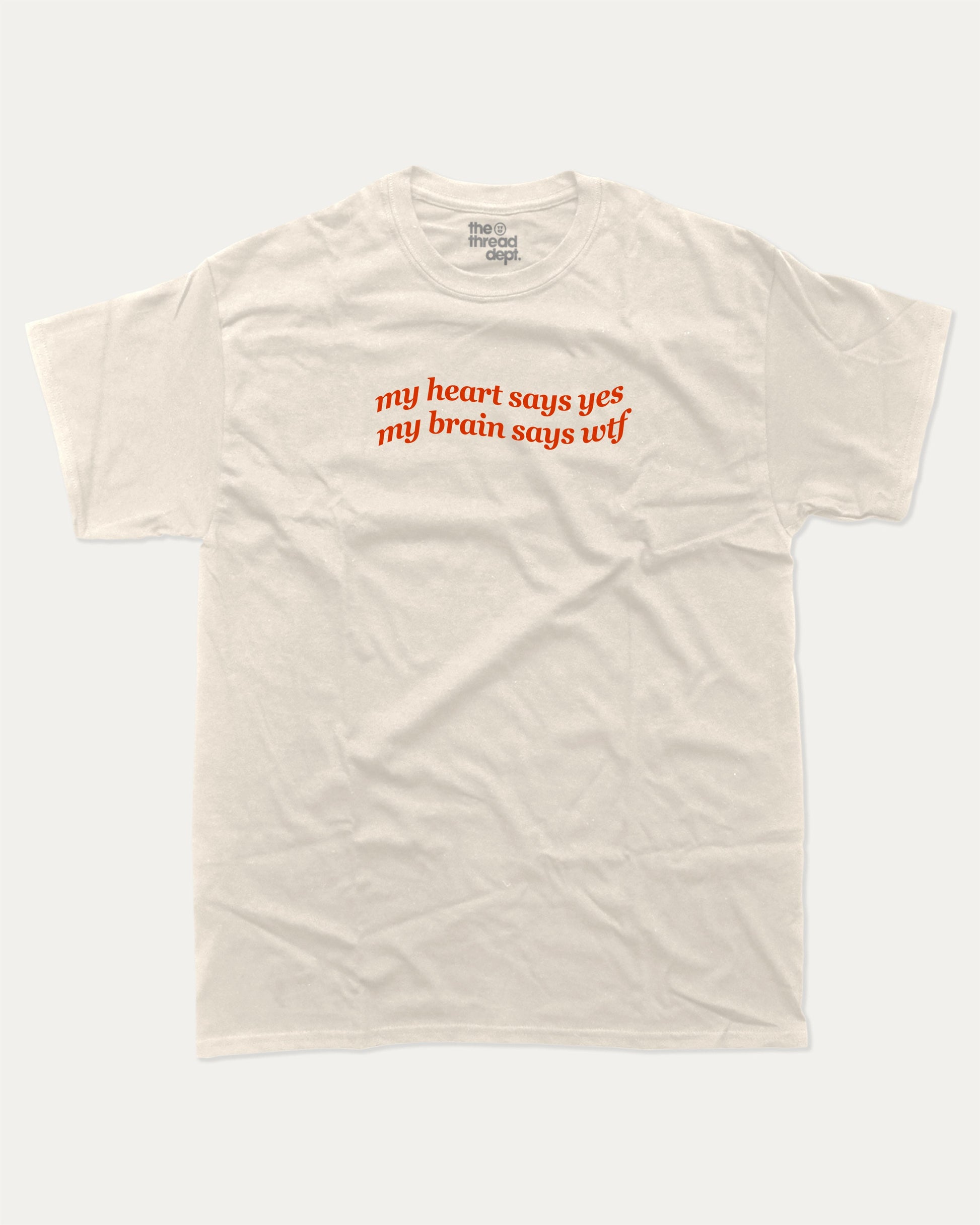 my heart says yes my brain says wtf graphic tee with bold and humorous print, funny and trendy graphic. Perfect for adults and gift-giving. Cream shirt.