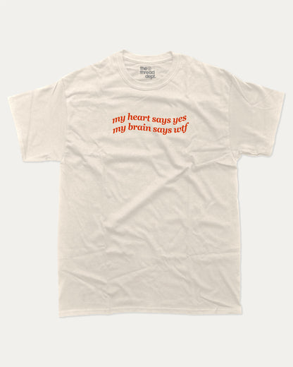 my heart says yes my brain says wtf graphic tee with bold and humorous print, funny and trendy graphic. Perfect for adults and gift-giving. Cream shirt.
