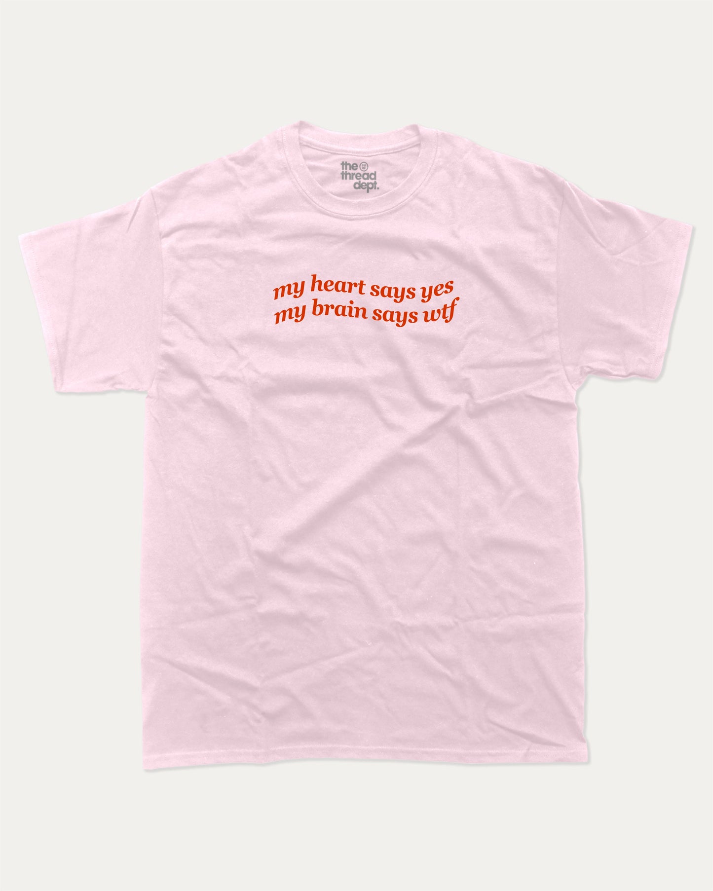my heart says yes my brain says wtf graphic tee with bold and humorous print, funny and trendy graphic. Perfect for adults and gift-giving. Pink shirt.