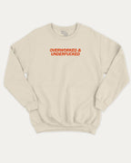 Overworked and Underfucked graphic sweatshirt with bold and humorous print, warm and cozy graphic for everyday wear. Perfect for adults and gift-giving. Natural pullover.