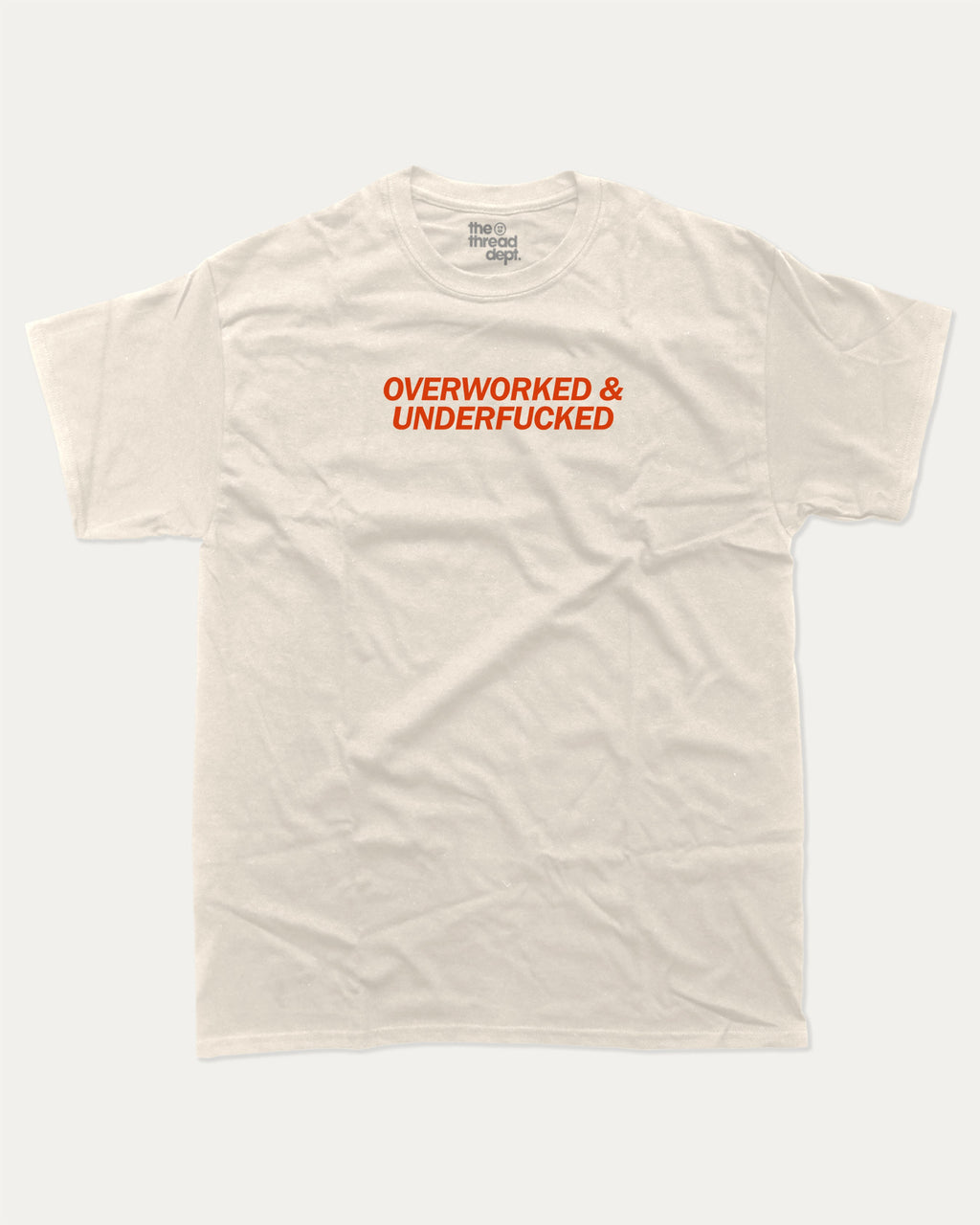 Overworked and Underfucked graphic tee with bold and humorous print, funny and trendy graphic. Perfect for adults and gift-giving. Cream shirt.