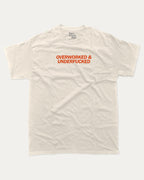Overworked and Underfucked graphic tee with bold and humorous print, funny and trendy graphic. Perfect for adults and gift-giving. Cream shirt.