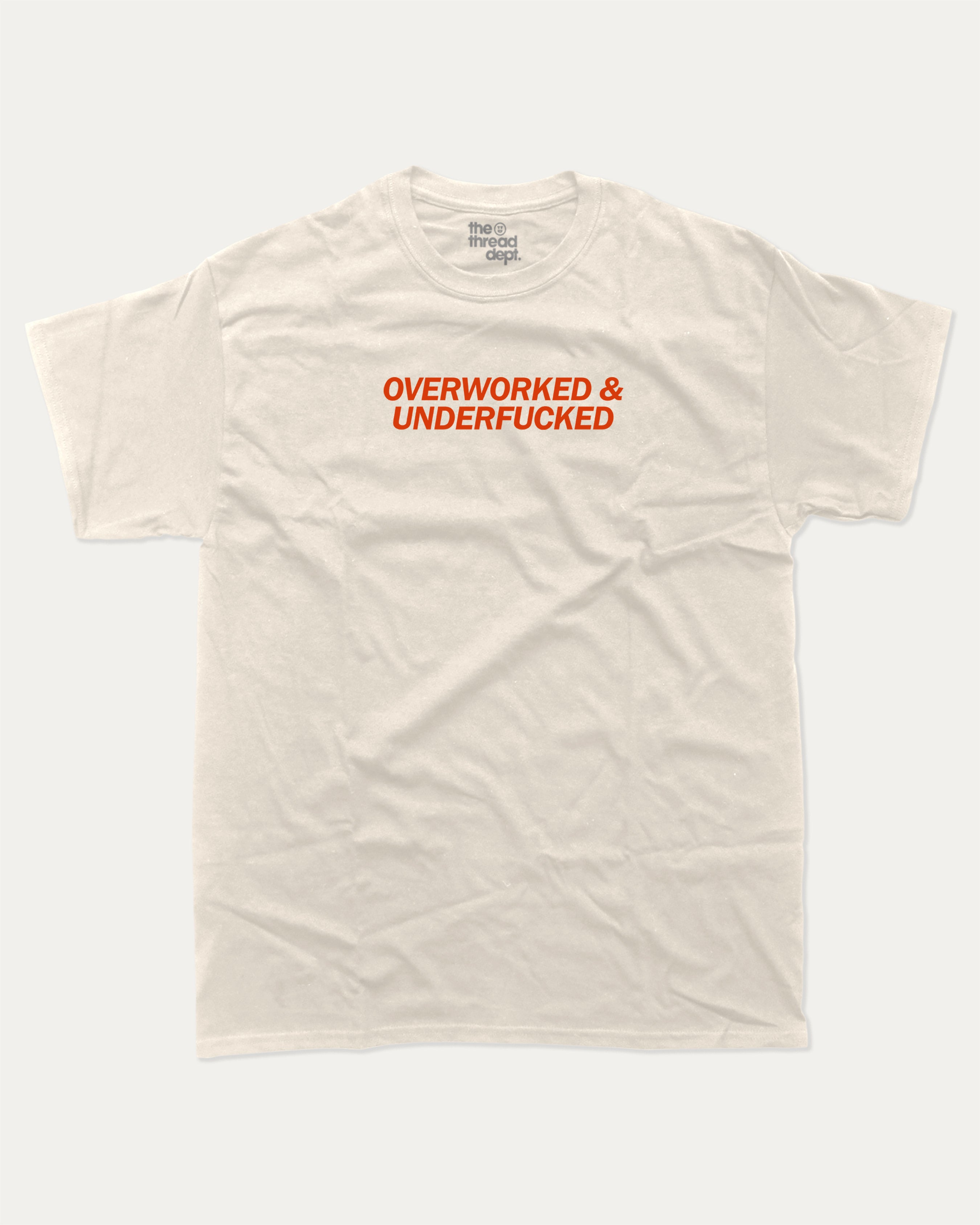 Overworked and Underfucked graphic tee with bold and humorous print, funny and trendy graphic. Perfect for adults and gift-giving. Cream shirt.