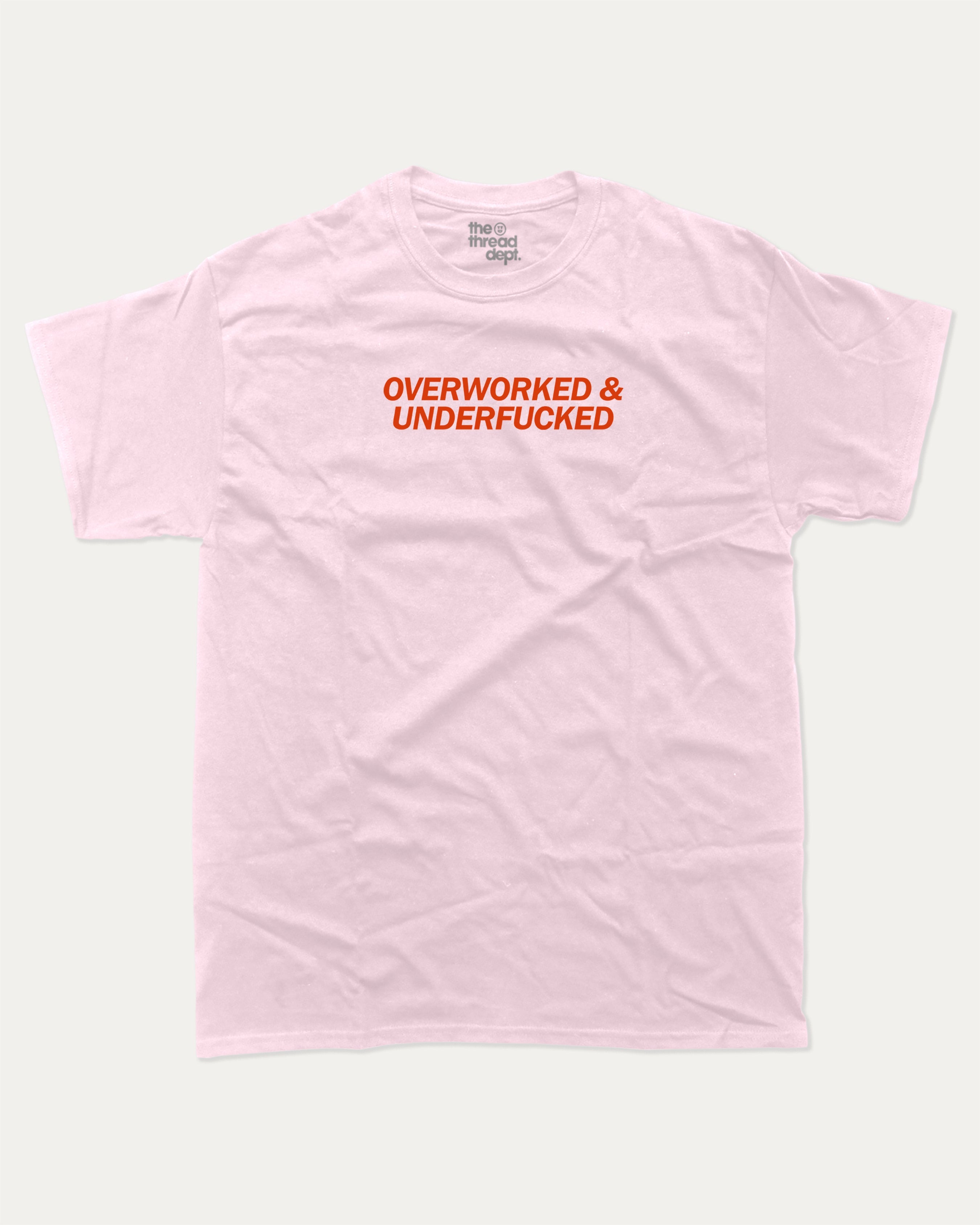 Overworked and Underfucked graphic tee with bold and humorous print, funny and trendy graphic. Perfect for adults and gift-giving. Pink shirt.
